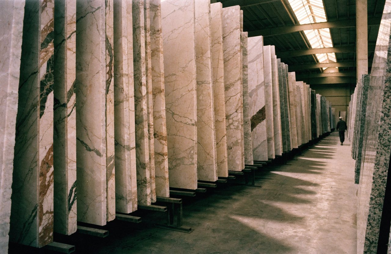 Polished marble and granite slabs racked in a stone trade warehouse